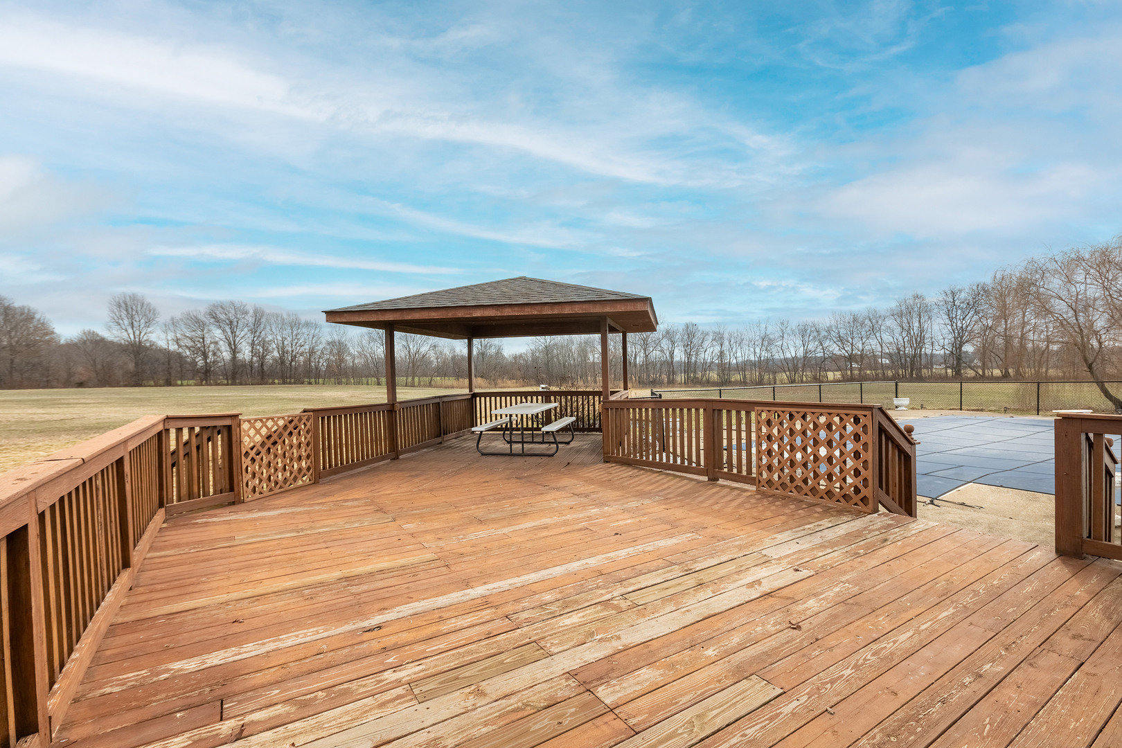 14798 Cherry Street Sesser, IL 62884 - Photo 30 of 37 a view of a deck with a table and chairs under an umbrella with wooden floor