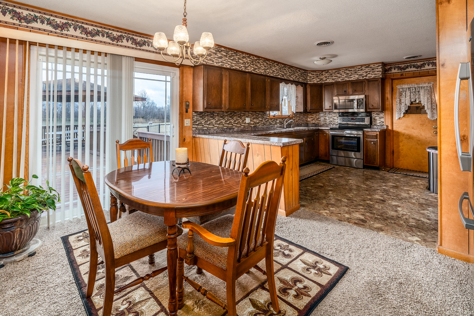 14798 Cherry Street Sesser, IL 62884 - Photo 6 of 37 a kitchen with stainless steel appliances granite countertop a stove a refrigerator a oven a sink with a dining table and chairs
