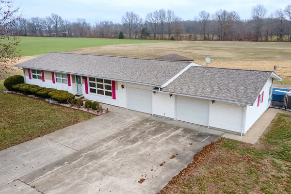 a view of a house with a yard and a large pool