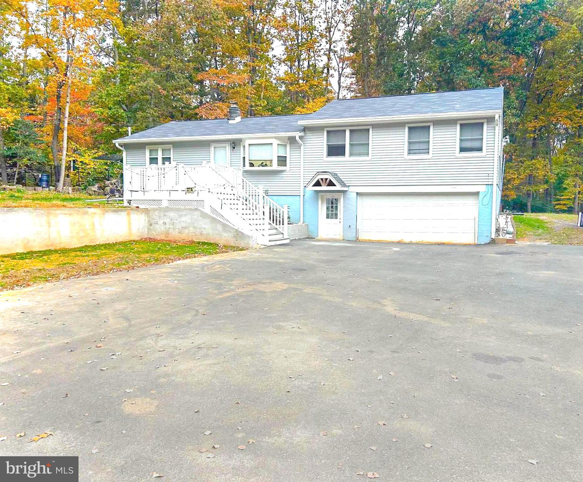 a front view of a house with a yard and a garage
