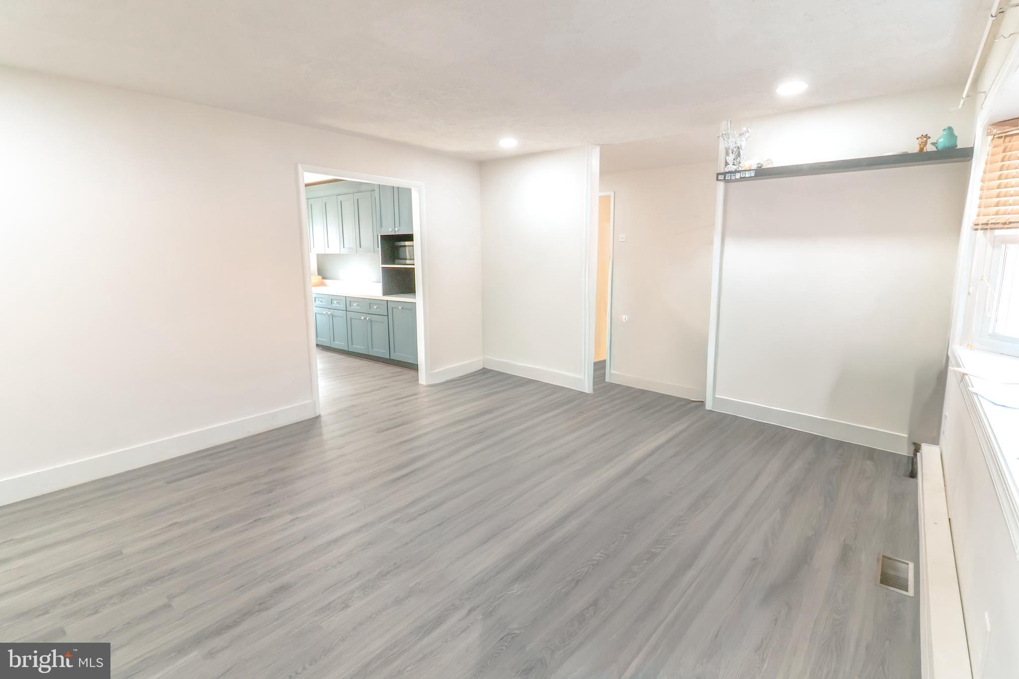 12704 Purcell Road Manassas, VA 20112 - Photo 11 of 47 a view of a big room with wooden floor and windows