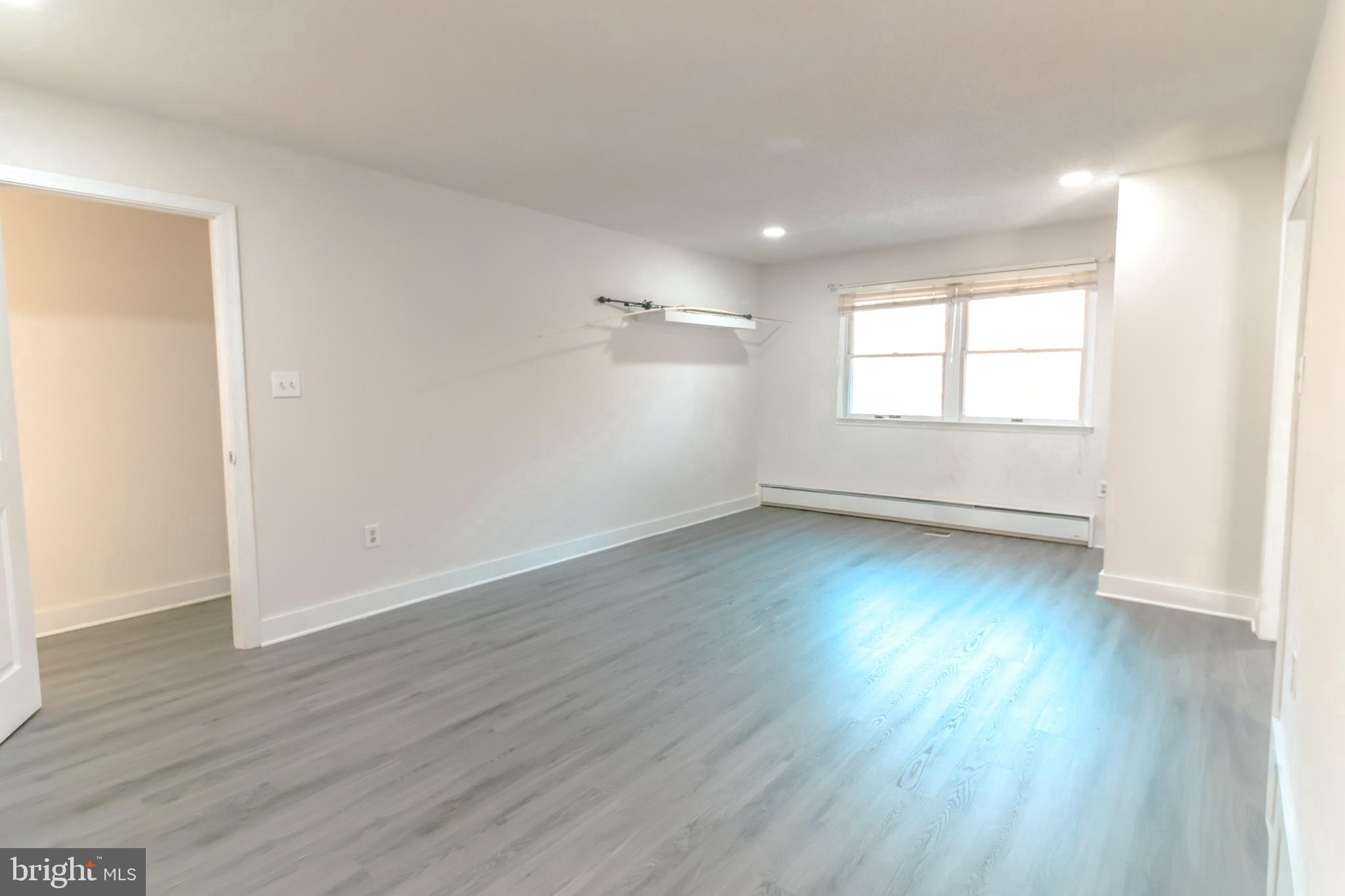 12704 Purcell Road Manassas, VA 20112 - Photo 16 of 47 an empty room with wooden floor and windows