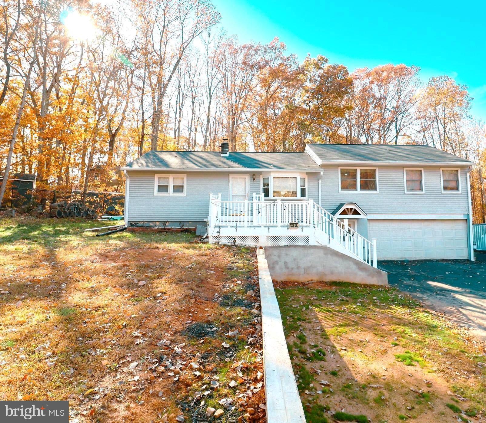 12704 Purcell Road Manassas, VA 20112 - Photo 2 of 47 a front view of a house with a yard and trees