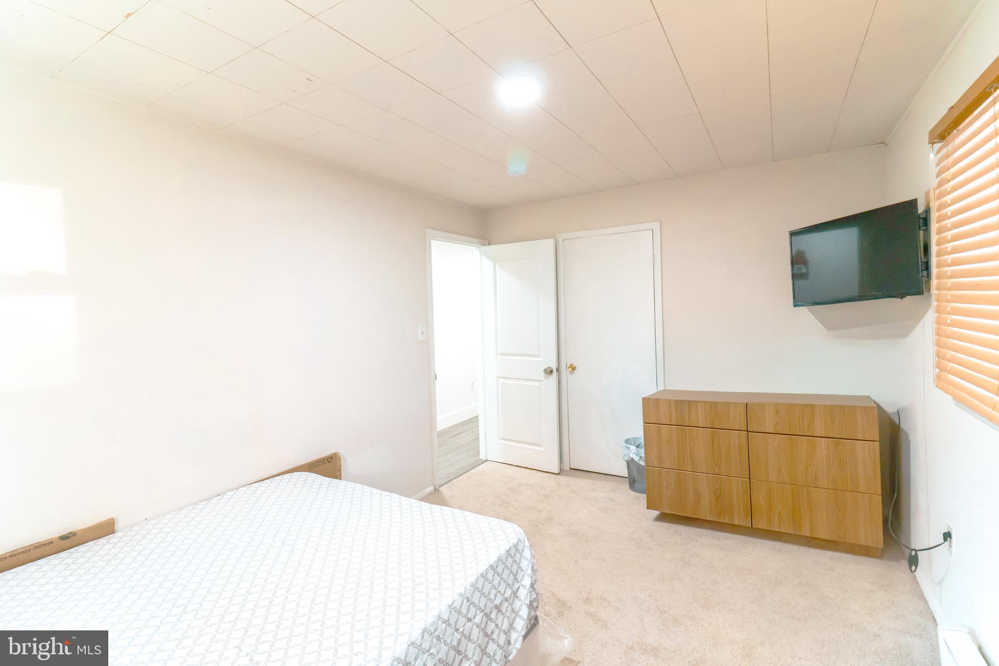 12704 Purcell Road Manassas, VA 20112 - Photo 22 of 47 a bedroom with a bed and a flat screen tv
