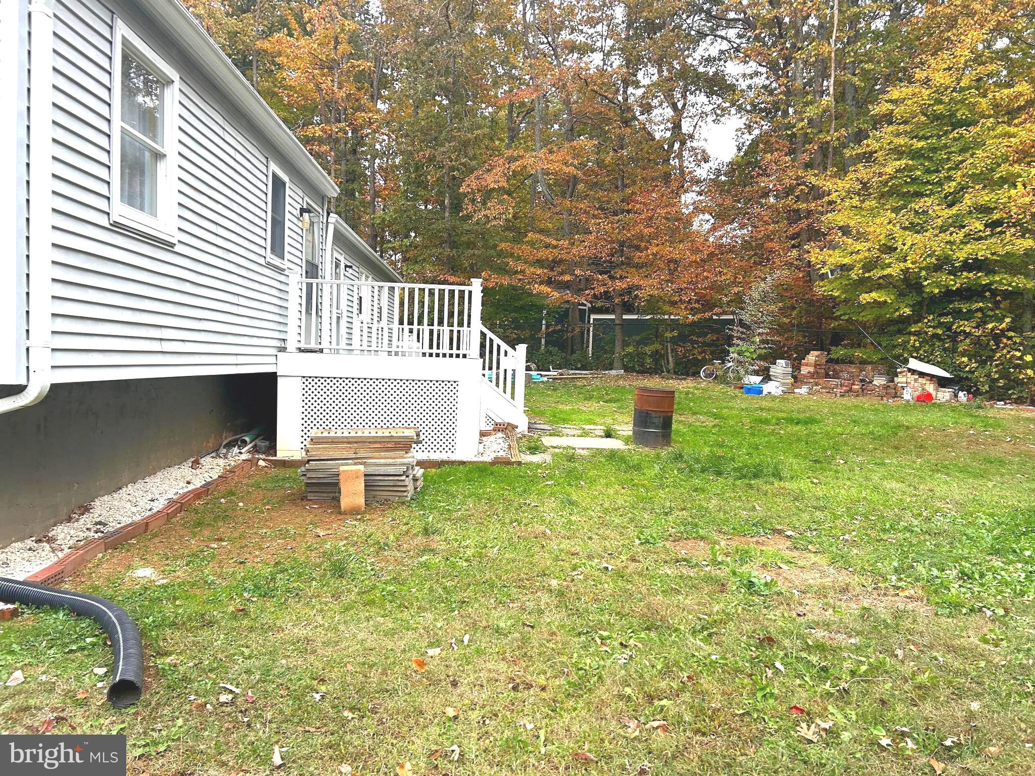 12704 Purcell Road Manassas, VA 20112 - Photo 32 of 47 a view of a house with a backyard and a bench