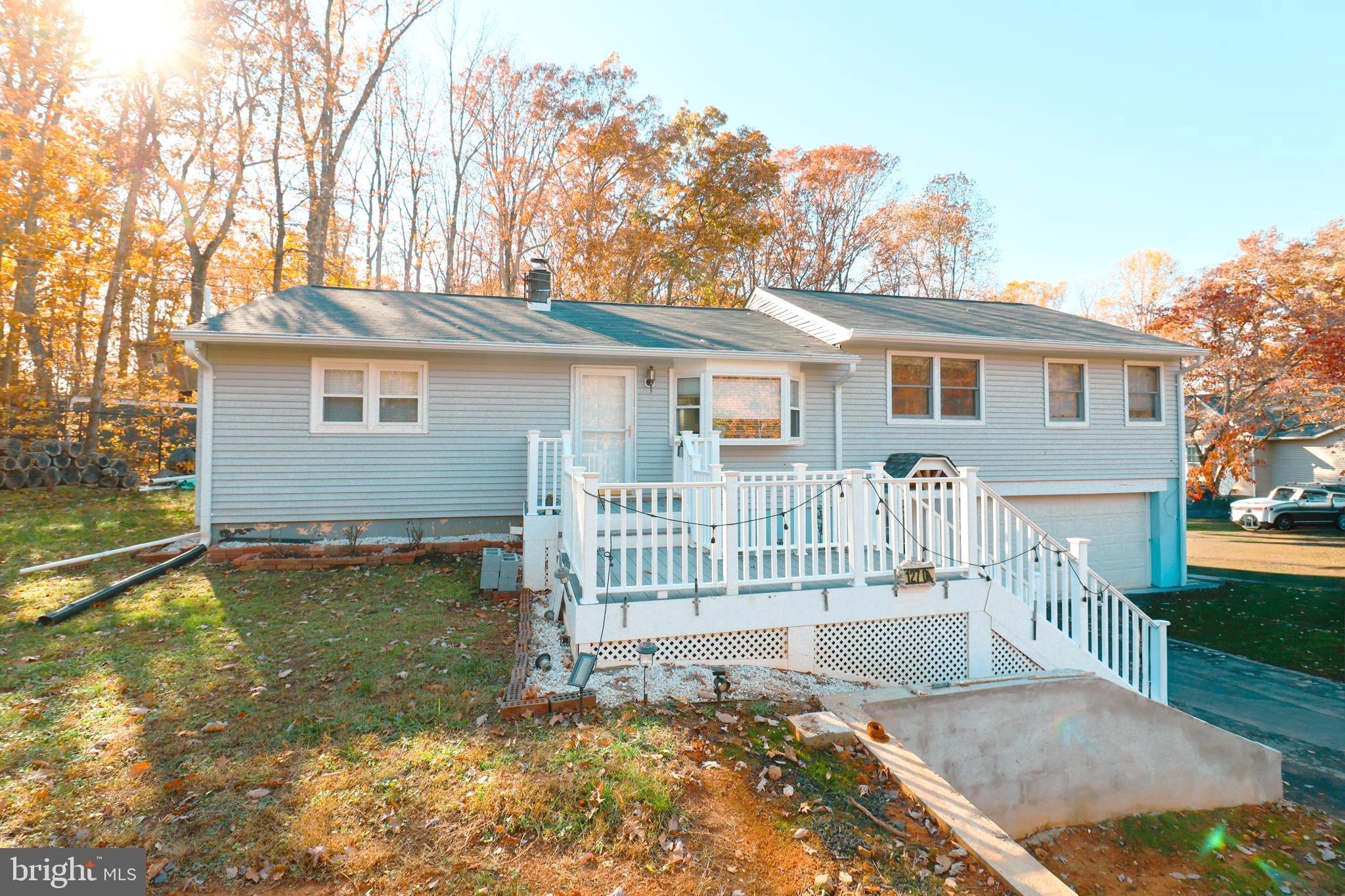 12704 Purcell Road Manassas, VA 20112 - Photo 4 of 47 a view of a house with a small yard and wooden fence