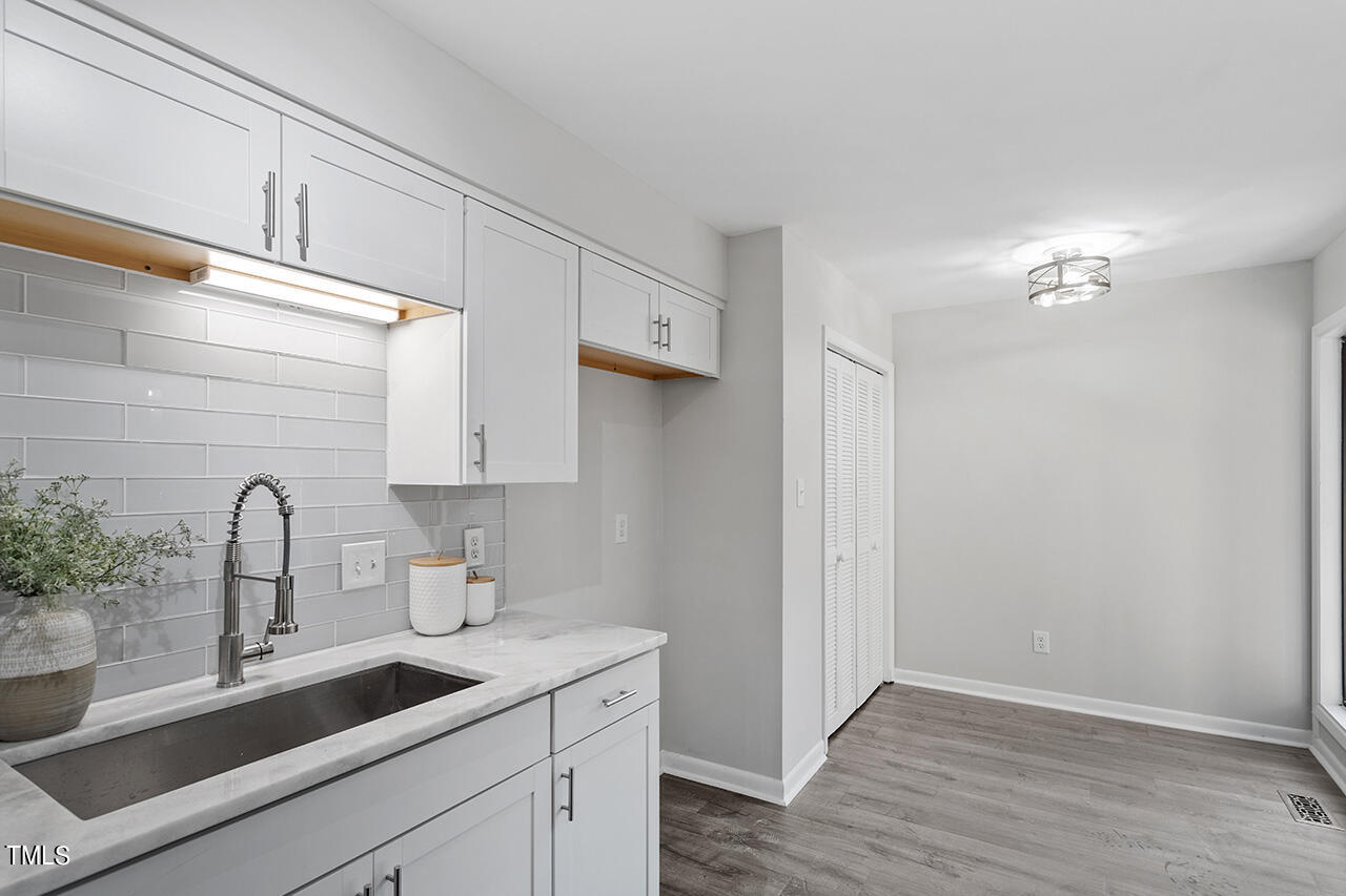 4100 Five Oaks Drive, Unit 46 Durham, NC 27707 - Photo 11 of 36 a kitchen with a sink cabinets and wooden floor