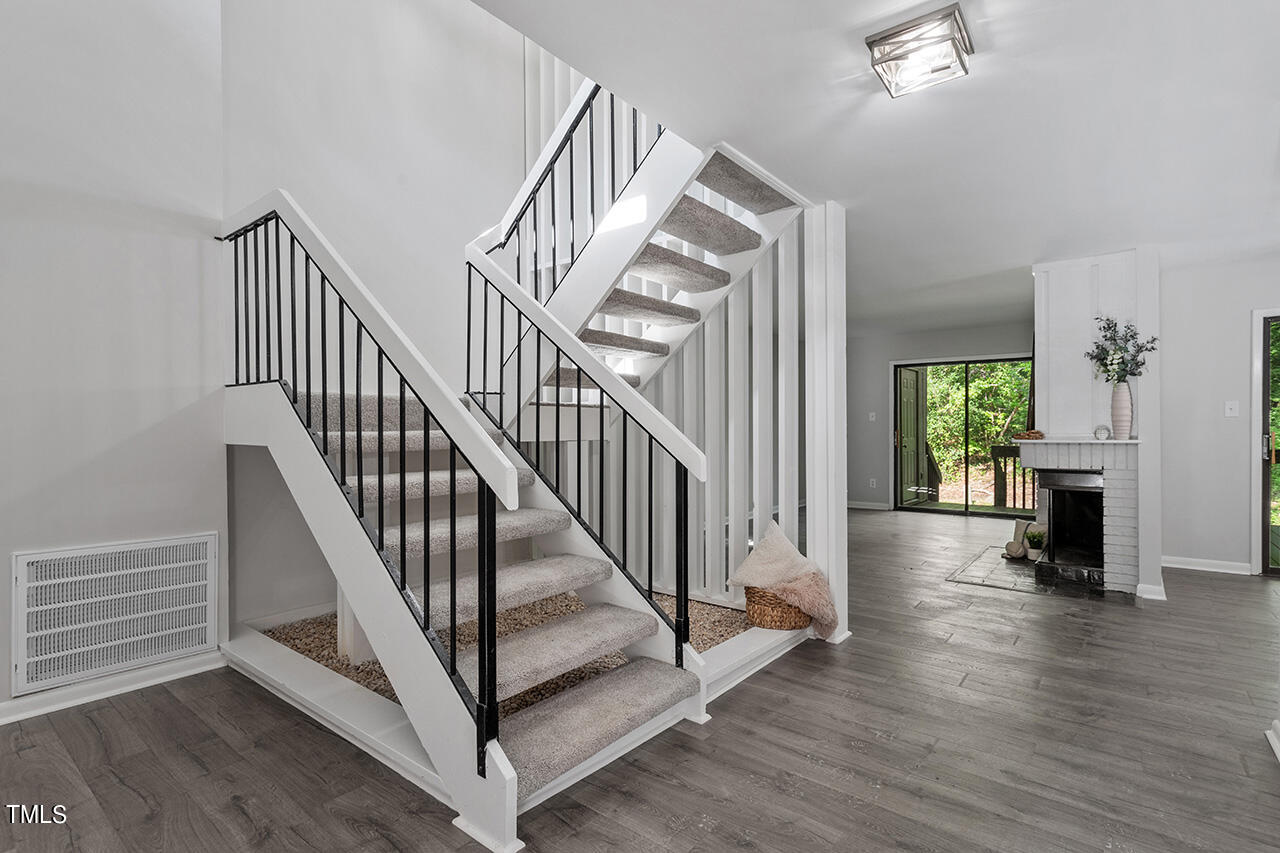 4100 Five Oaks Drive, Unit 46 Durham, NC 27707 - Photo 14 of 36 a view of staircase with wooden floor and a chandelier