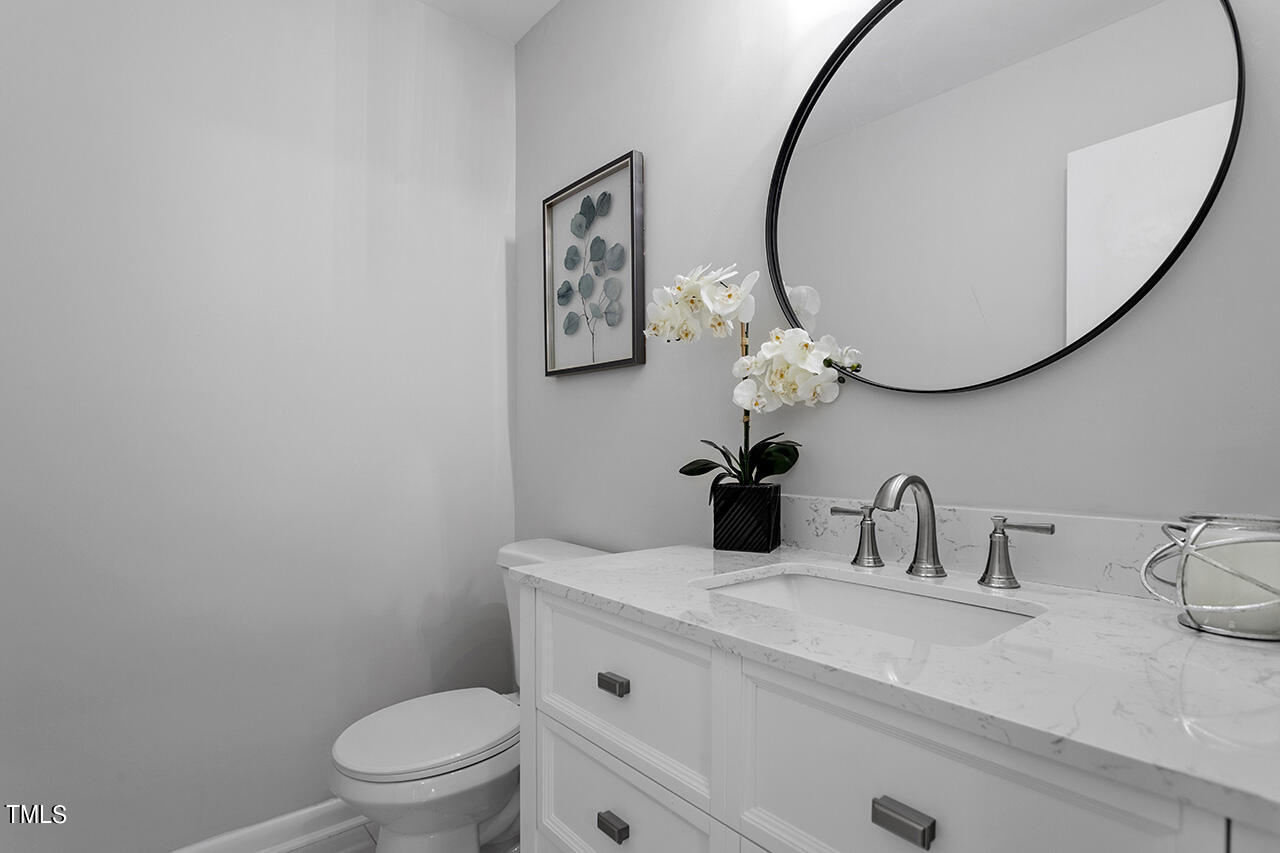 4100 Five Oaks Drive, Unit 46 Durham, NC 27707 - Photo 23 of 36 a bathroom with a sink a mirror a toilet and a sink