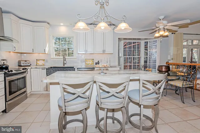 a kitchen with a table chairs stove and cabinets