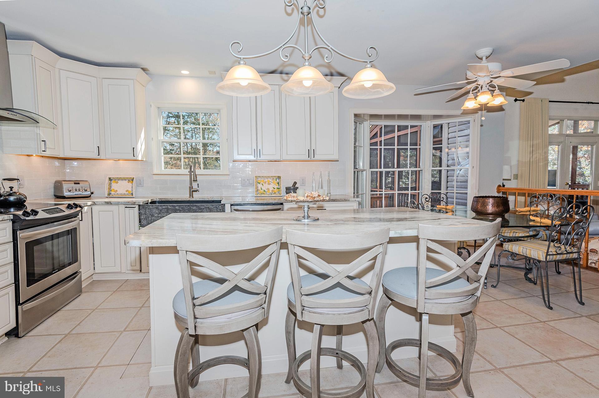 621 Wood Lot Trail Road Annapolis, MD 21401 - Photo 14 of 44 a kitchen with a table chairs stove and cabinets