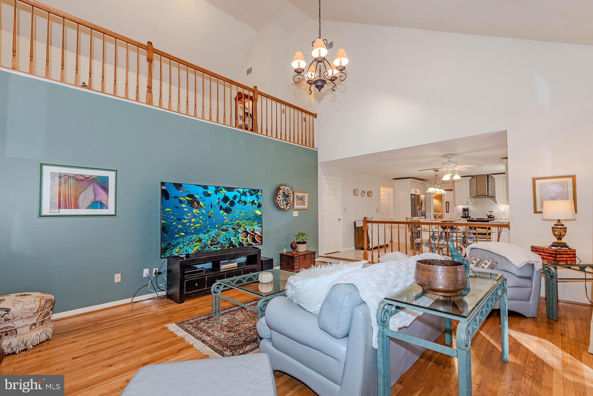 621 Wood Lot Trail Road Annapolis, MD 21401 - Photo 21 of 44 a living room with furniture a dining table and a chandelier