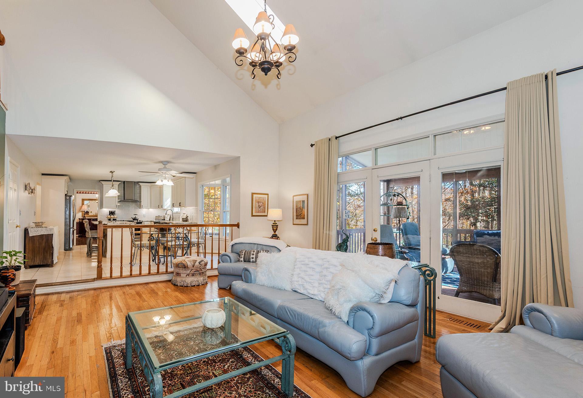 621 Wood Lot Trail Road Annapolis, MD 21401 - Photo 22 of 44 a living room with furniture a chandelier and a dining table