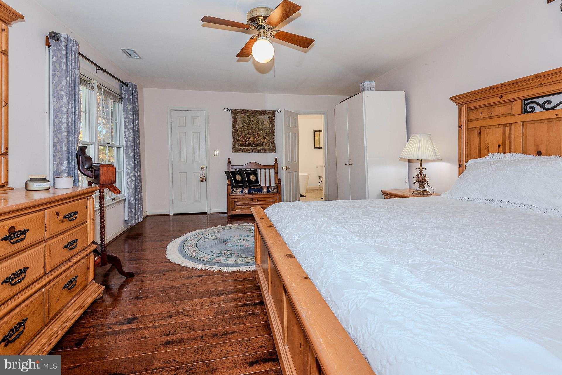 621 Wood Lot Trail Road Annapolis, MD 21401 - Photo 26 of 44 a bedroom with a bed and wooden floor