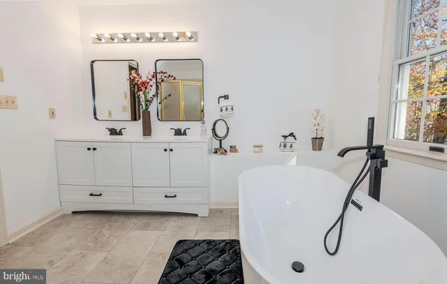 a bathroom with a mirror a sink and a mirror