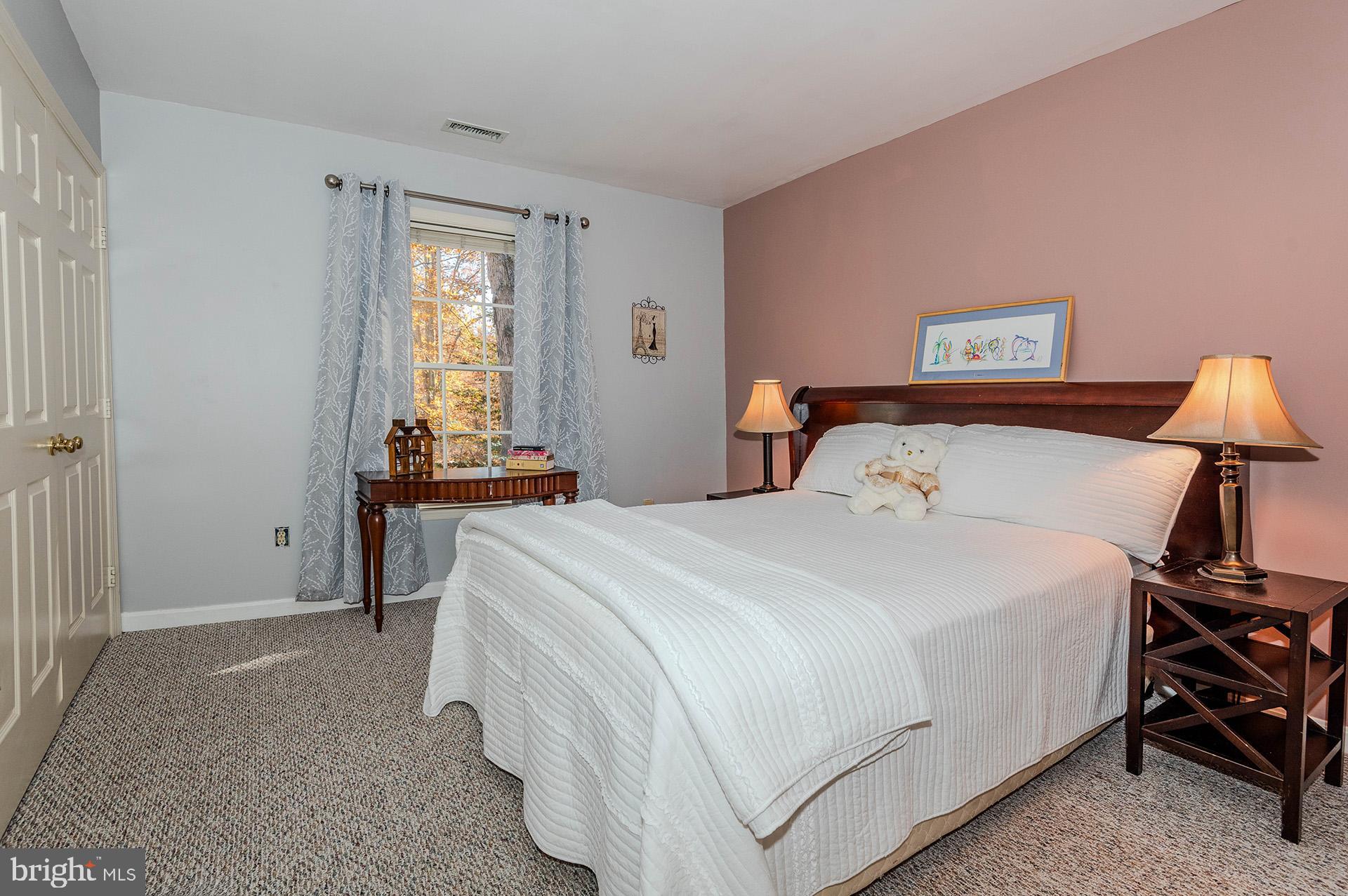 621 Wood Lot Trail Road Annapolis, MD 21401 - Photo 30 of 44 a bedroom with a bed and a lamp on the dresser