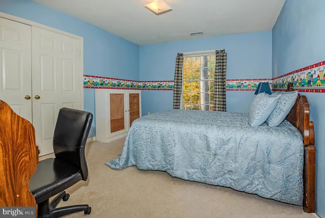 a bedroom with a bed chair and window