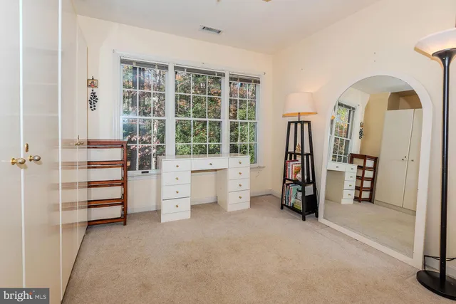 an empty room with windows and closet