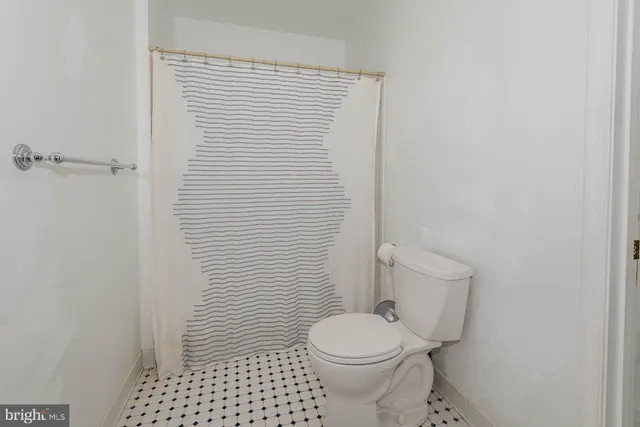 a white toilet sitting next to a white sink
