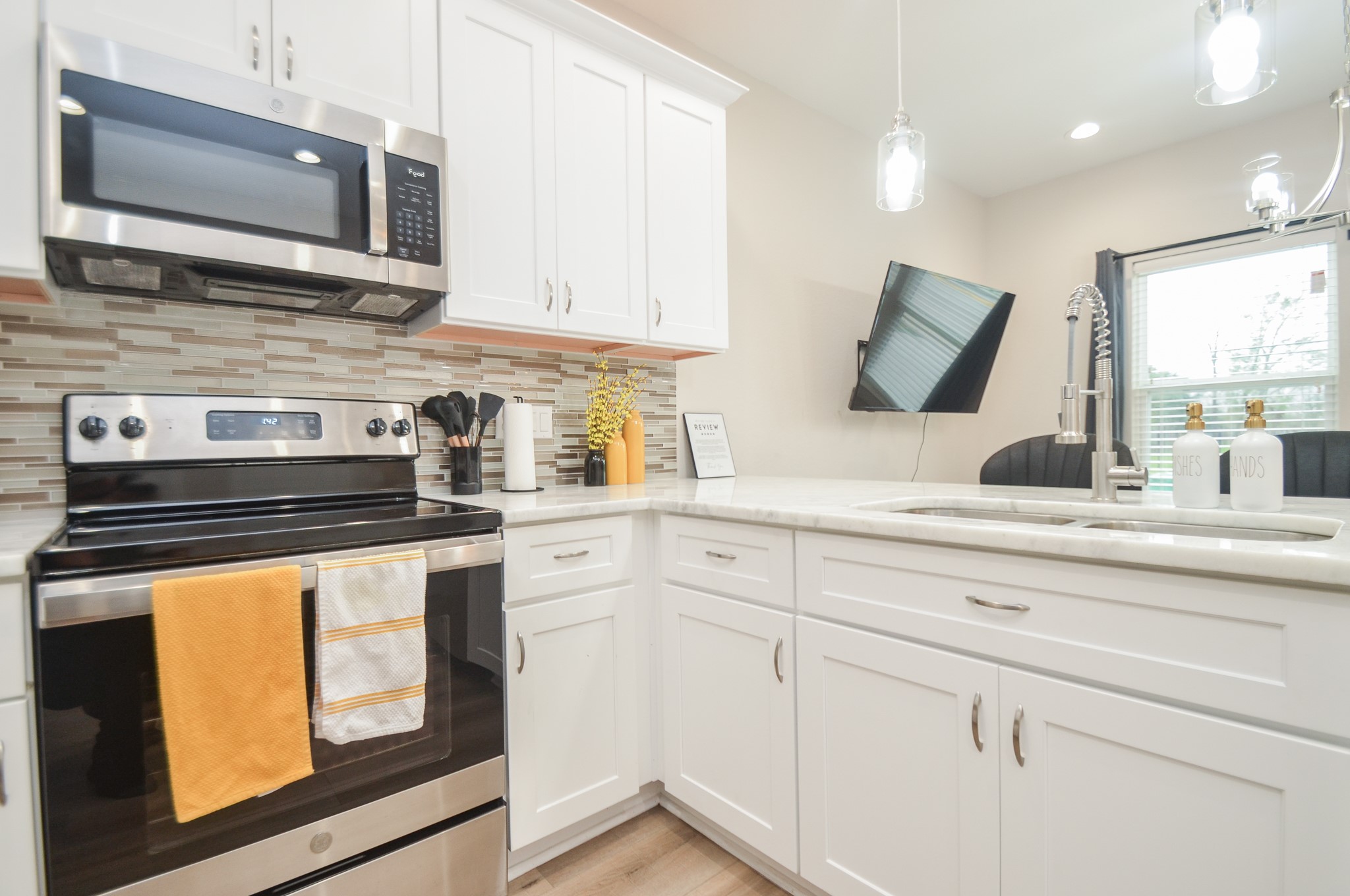 4511 Reed Road Houston, TX 77051 - Photo 15 of 39 a kitchen with stainless steel appliances white cabinets and a stove top oven