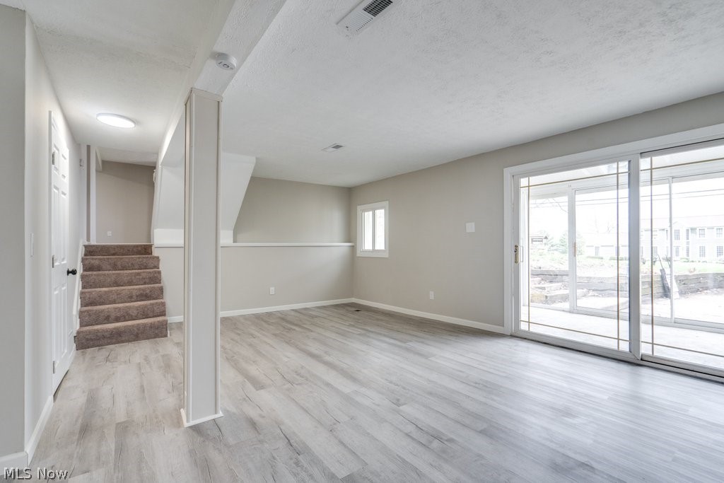 4596 Hattrick Road Rootstown, OH 44272 - Photo 41 of 45 Basement featuring light hardwood / wood-style floors and a textured ceiling