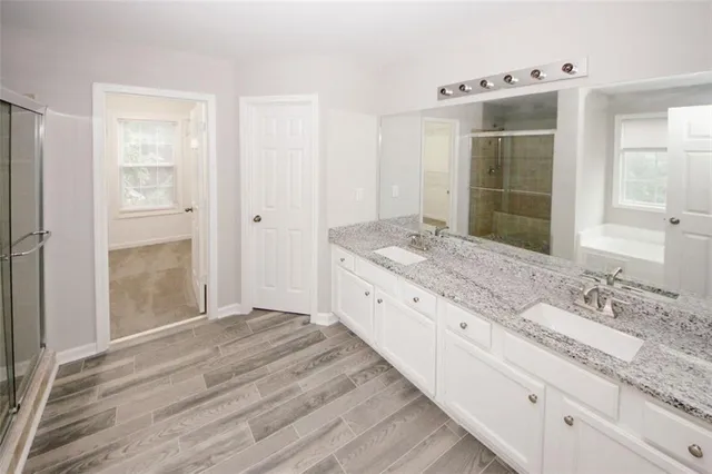 a spacious bathroom with a granite countertop sink mirror and double