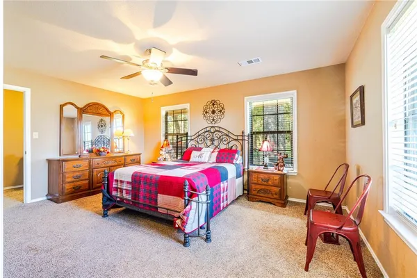 a bedroom with bed and a window