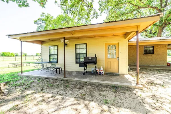 a view of a house with backyard porch and sitting area