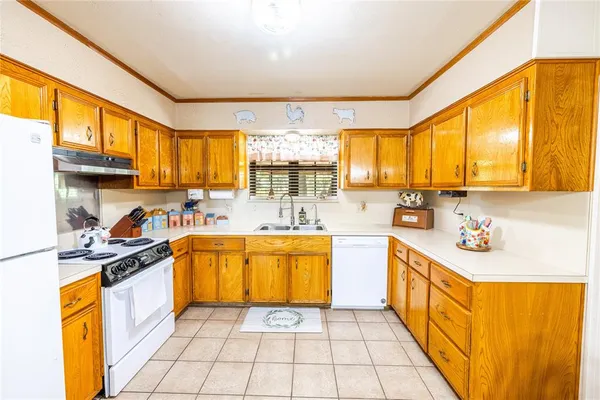 a kitchen with stainless steel appliances granite countertop sink stove top oven and cabinets