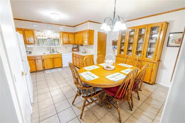a view of a dining room with furniture and chandelier