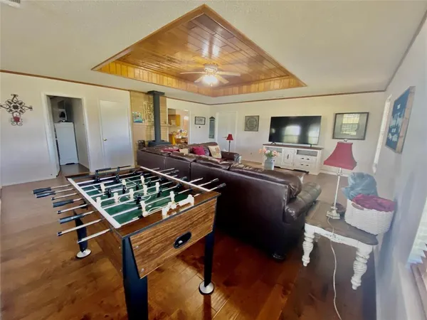a living room with furniture gym equipment and a flat screen tv