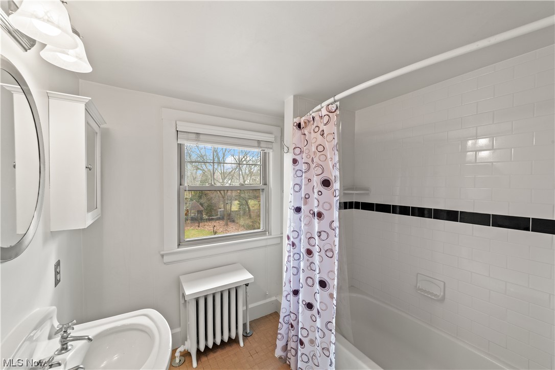 2745 Leighton Road Cleveland, OH 44120 - Photo 34 of 46 Bathroom with sink, shower / bathtub combination with curtain, and radiator