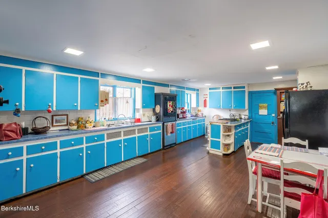 a kitchen with lots of counter top space and wooden floor