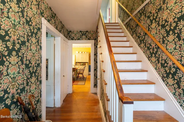 a view of entryway and hall with wooden floor