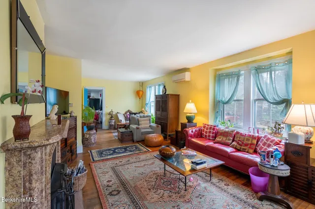 a living room with furniture fireplace and a flat screen tv