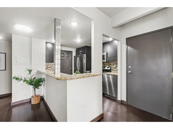 a view of kitchen with refrigerator and window