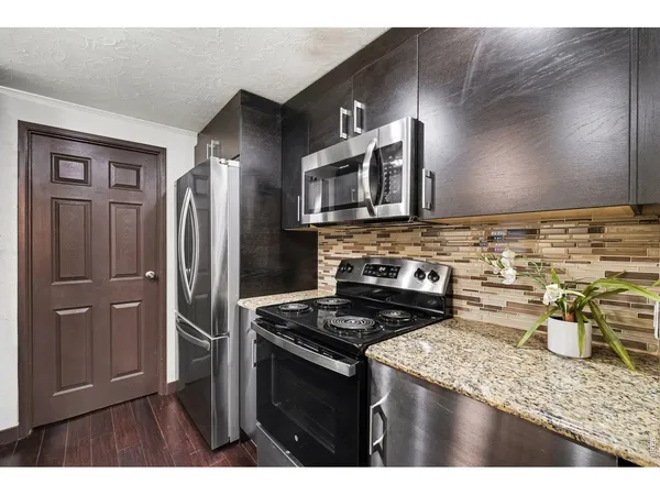 a kitchen with a stove and a refrigerator