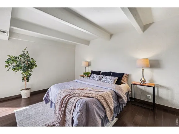a bedroom with a bed and a potted plant