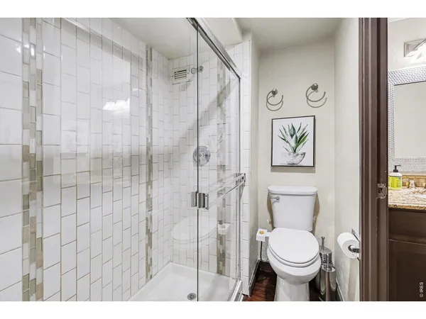 a bathroom with a toilet sink and shower