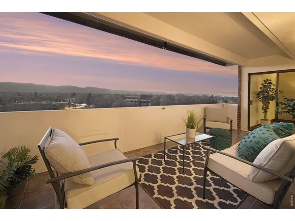 a view of a terrace with couches and lounge chairs