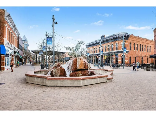a roof deck with table and chairs