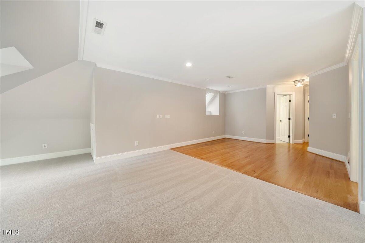 6300 Swallow Cove Lane Raleigh, NC 27614 - Photo 47 of 67 an empty room with wooden floor and natural light