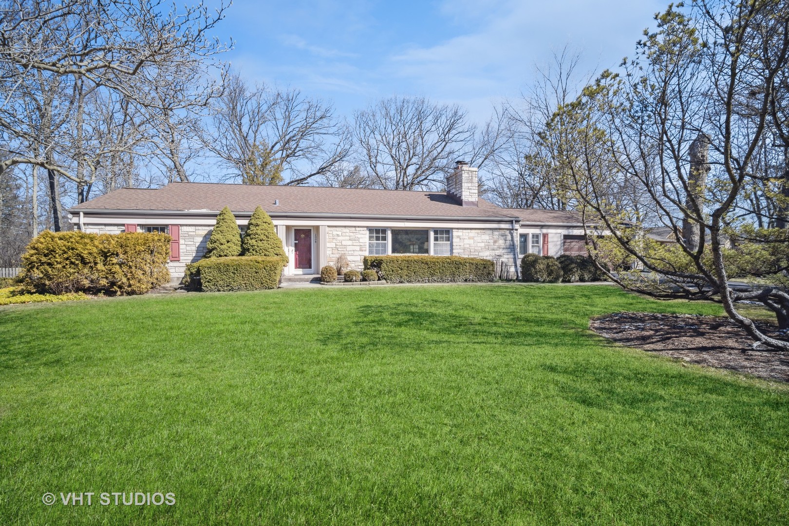 2009 Sunset Ridge Road Glenview, IL 60025 - Photo 2 of 25 a front view of a house with a garden