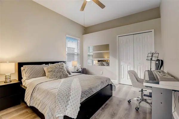 a bedroom with a bed and a chandelier