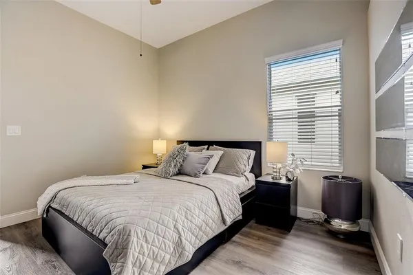 a bed room with a bed window and a chair
