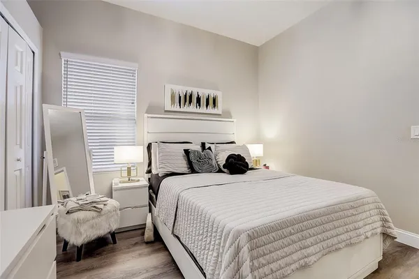 a bedroom with bed and window