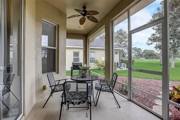 a dining room with furniture water view and a floor to ceiling window