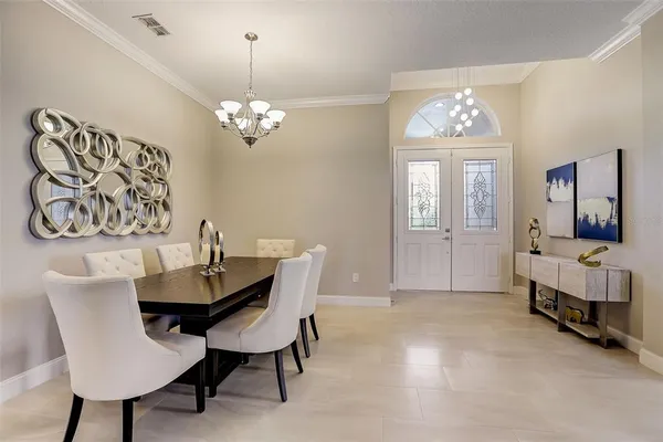 a view of a dining room with furniture and a chandelier
