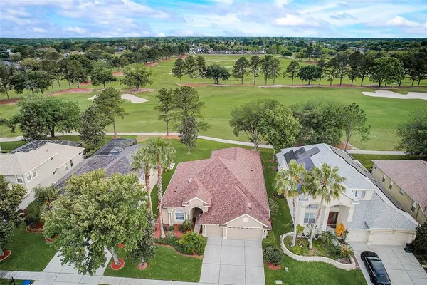 an aerial view of a house with yard