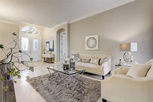 a living room with furniture and wooden floor